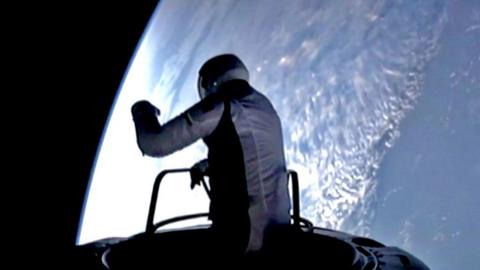 Astronaut silhouetted on Earth