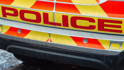 Generic image of a police vehicle. The close-up shows the back of the vehicle with the word "police" in red letters.