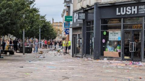 A police cordon in place on King Edward Street in Hull. Outside the Lush store, the colourful remnants of soaps and bath bombs can be seen on the ground.