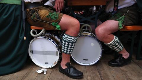 Musicians in traditional costumes gather in a tent after a parade during the 189th edition of the Oktoberfest beer and amusement festival