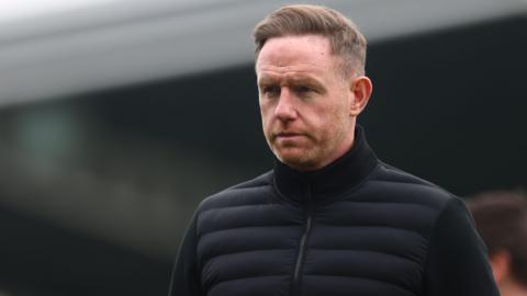 Shrewsbury Town head coach Gavin Cowan walks on to the pitch pre-match 