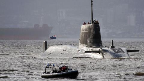 HMS Astute, the first of the Astute class attack submarines, leaving the Clyde with a Royal Navy dinghy escort. 