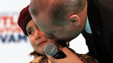 Turkish President Recep Tayyip Erdogan kisses a girl dressed as a Turkish soldier during the 6th ordinary provincial congress of the Justice and Development Party (AKP)