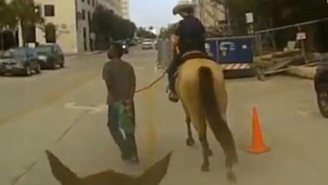 Officers on horseback tethered a black man to a rope and escorted him through the city to a police station.