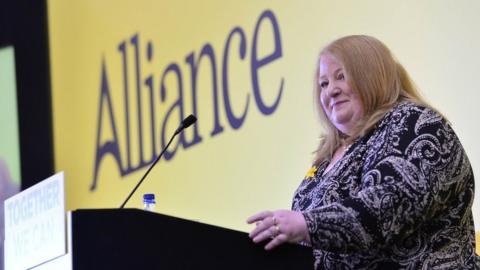 Naomi Long addressing the conference