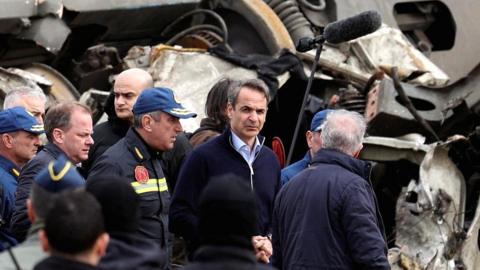 Greek Prime Minister Kyriakos Mitsotakis visits the site of a crash, where two trains collided