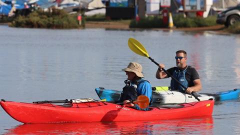 Kayakers on a car park