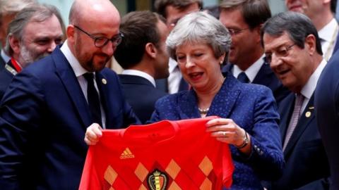 Theresa May receives Belgium"s national soccer team jersey from Belgian Prime Minister Charles Michel