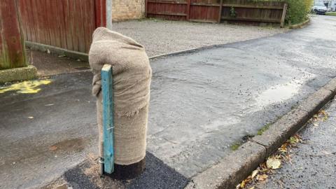 Cut down telegraph pole wrapped in fabric