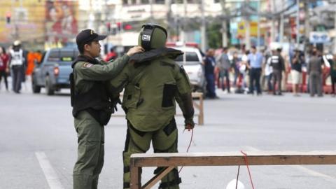 A Thai members of Explosive Ordnance Disposal (EOD) helps his colleague in the centre of Hua Hin city, Thailand