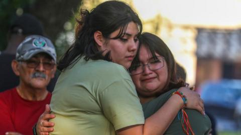 Visitors at a memorial to the Uvalde shooting victims