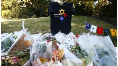 A "Stronger Than Hate" t-shirt, messages, and flowers are left near the Tree of Life synagogue three days after a mass shooting in Pittsburgh, Pennsylvania