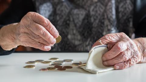 Older woman counting coins