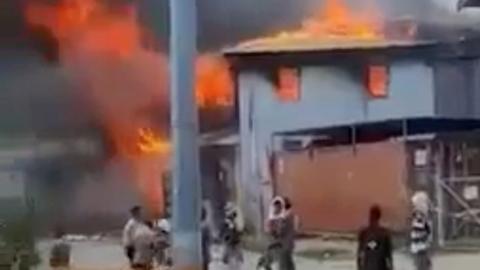 A building burns in Chinatown as Solomon Islanders defied a government-imposed lockdown and protested in Honiara