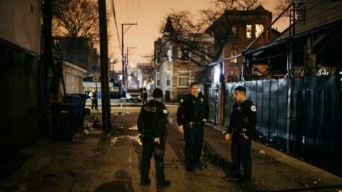 Police search the crime scene outside of the apartment complex where the officer was shot in a apartment raid in Humboldt Park In Chicago, Illinois, on 10 March 2019
