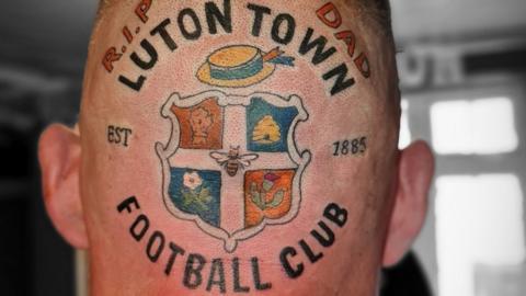 A tattoo of Luton Town's badge on the back of a head