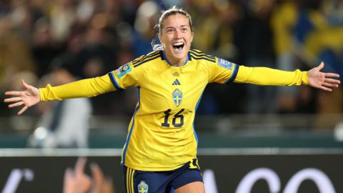 Filippa Angeldal runs with arms outstretched, celebrating Sweden's second goal
