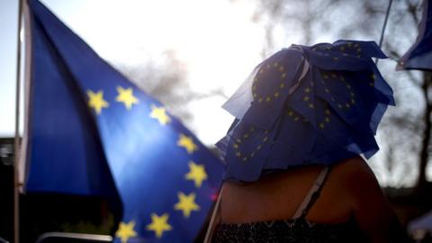 Woman wearing a hat made of EU flags
