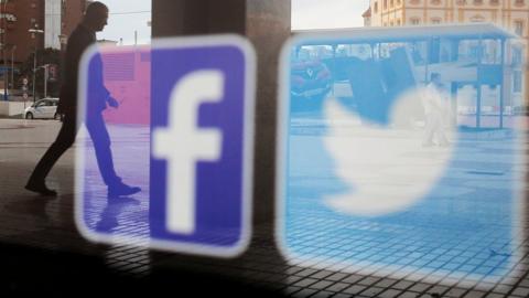 Facebook and Twitter logos on a shop window in Malaga, Spain, 4 June 2018