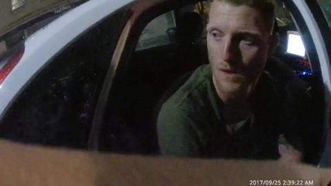Ben Stokes sitting in a police car