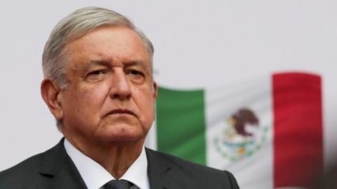 President Andres Manuel Lopez Obrador listens to the national anthem as he arrives to address the nation on his second anniversary as President of Mexico, at the National Palace in Mexico City, Mexico, December 1, 2020.