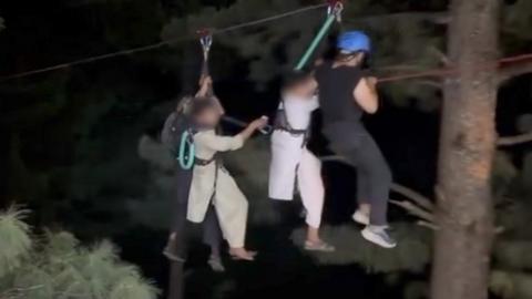 Zip line rescuers pull children to safety