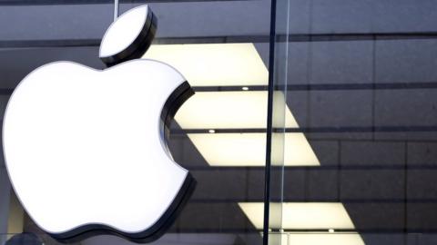 Apple logo over a glass shop front