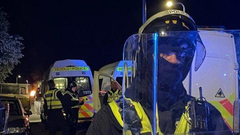 Riot police at the scene of disorder in the district of Ely in Cardiff