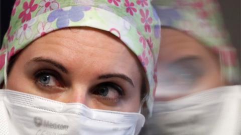 A nurse wearing a protective mask