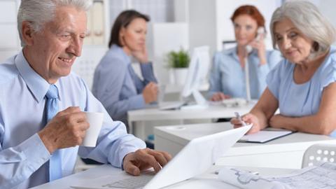 Baby boomers, aged 50-70, working in an office