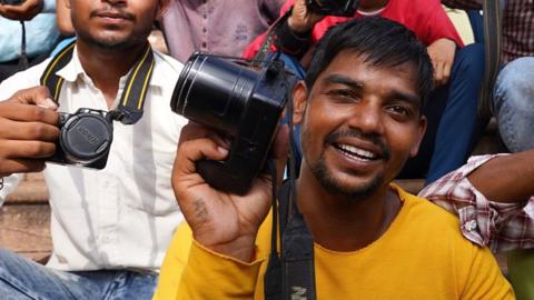 Photographers posing outside the temple