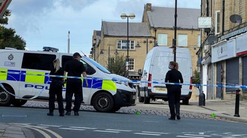 Officers in front of a police van