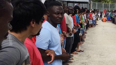 Refugees and asylum seekers at the Manus Island immigration detention centre lock hands in solidarity ahead of the camp's closure, 31 October 2017