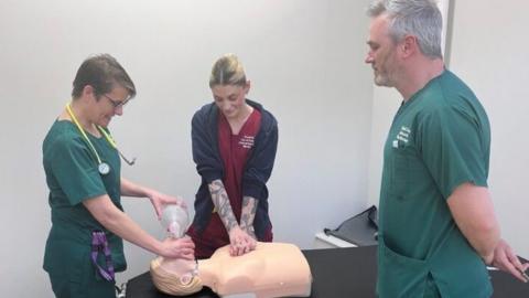 Pilgrim Hospital staff perform CPR on a mannequin