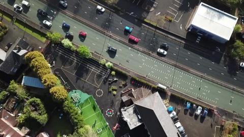 A primary school in Manchester sits on one of Europe's busiest roads where particle pollution levels exceed WHO limits.