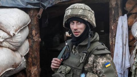 A Ukrainian service member is seen on the front line near the city of Novoluhanske in the Donetsk region