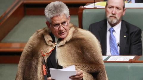 Ken Wyatt, wearing a traditional kangaroo skin coat, delivers his maiden speech in parliament