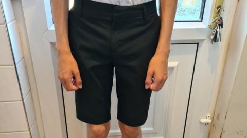 Image of a schoolboy wearing a pair of shorts