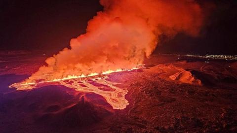 A volcano spews lava and smoke as it erupts, near Grindavik