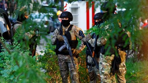 Police at the site of a Kyiv district court, where an explosive device was activated by a man.