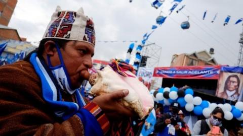 A man plays a seashell during a closing campaign rally of the Presidential candidate Luis Arce of the Movement to Socialism party (MAS) ahead of the Bolivian presidential election, in El Alto, on the outskirts of La Paz, Bolivia, October 14, 2020