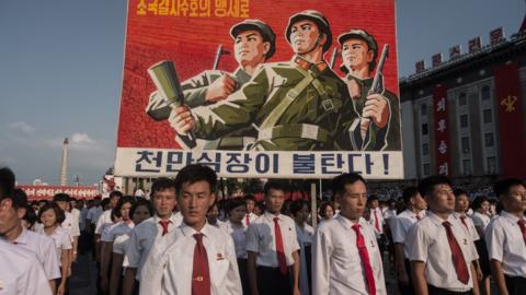 - A propaganda poster is displayed during a rally in support of North Korea's stance against the US, on Kim Il-Sung square in Pyongyang on August 9, 2017.