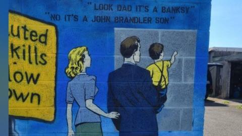 John Doh's art, which reads: "Look dad it's a Banksy"; and "No it's a John Brandler son"