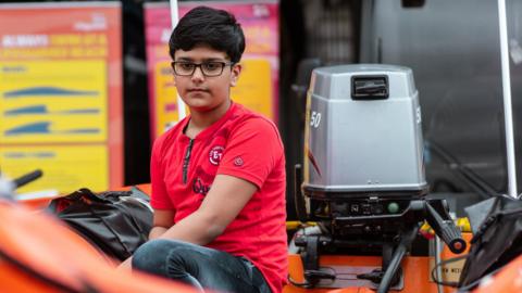 Raini sitting in a lifeboat