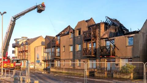 Fire-damaged flats at Nairn Harbour