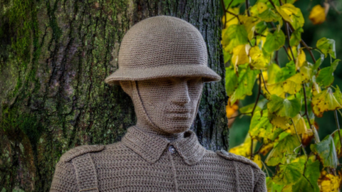 The head and shoulders of a crochet soldier