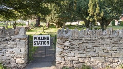 Polling station sign on gate