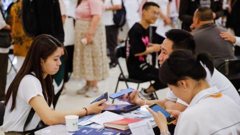 Job seekers and recruiters at a job fair in Beijing, China.