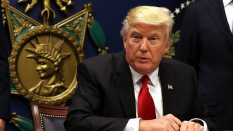 Donald Trump signs an executive order to impose tighter vetting of travellers entering the United States on January 27, 2017.