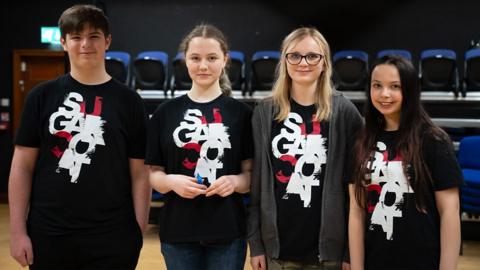 A group of young people standing in a row